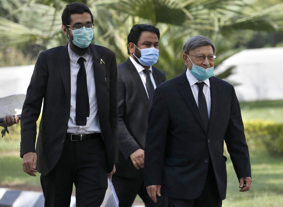 Farooq Naek, center, prosecutor from Sindh provincial government, arrives with his team at the Supreme Court for an appeal hearing of Daniel Pearl case, in Islamabad, Pakistan, Monday, Sept. 28, 2020. Pakistan's Supreme Court is to hear an appeal Monday by the family of slain American journalist Pearl that challenges the acquittal of a British-born Pakistani in the gruesome 2002 beheading of the Wall Street Journal reporter. (AP Photo/Anjum Naveed)