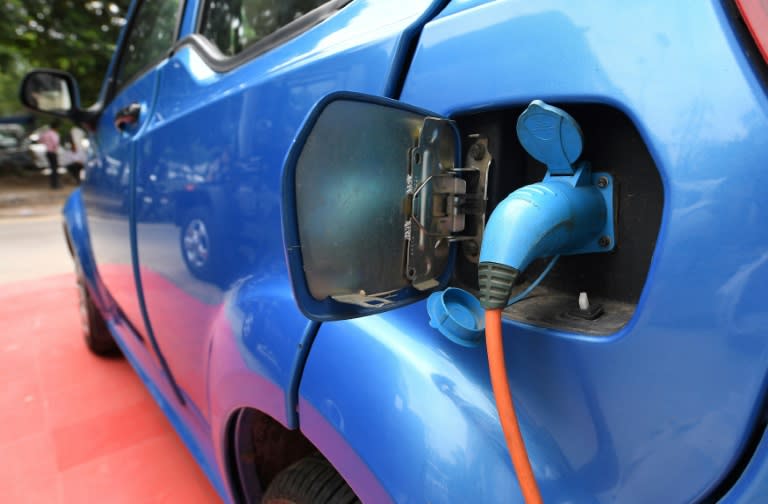 Mahindra's electric car "e2o Plus" is plugged in for charging, at a showroom in New Delhi