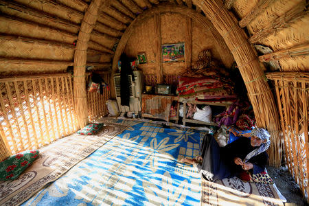 An Iraqi Marsh Arab man sits in his house which is made of reeds at the Chebayesh marsh in Dhi Qar province, Iraq April 13, 2019. REUTERS/Thaier al-Sudani