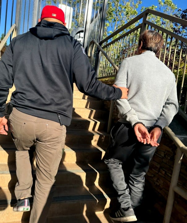 Tuen Kit “Dickie” Lee is led away in handcuffs on May 28, 2024. (Image courtesy U.S. Marshals Service)