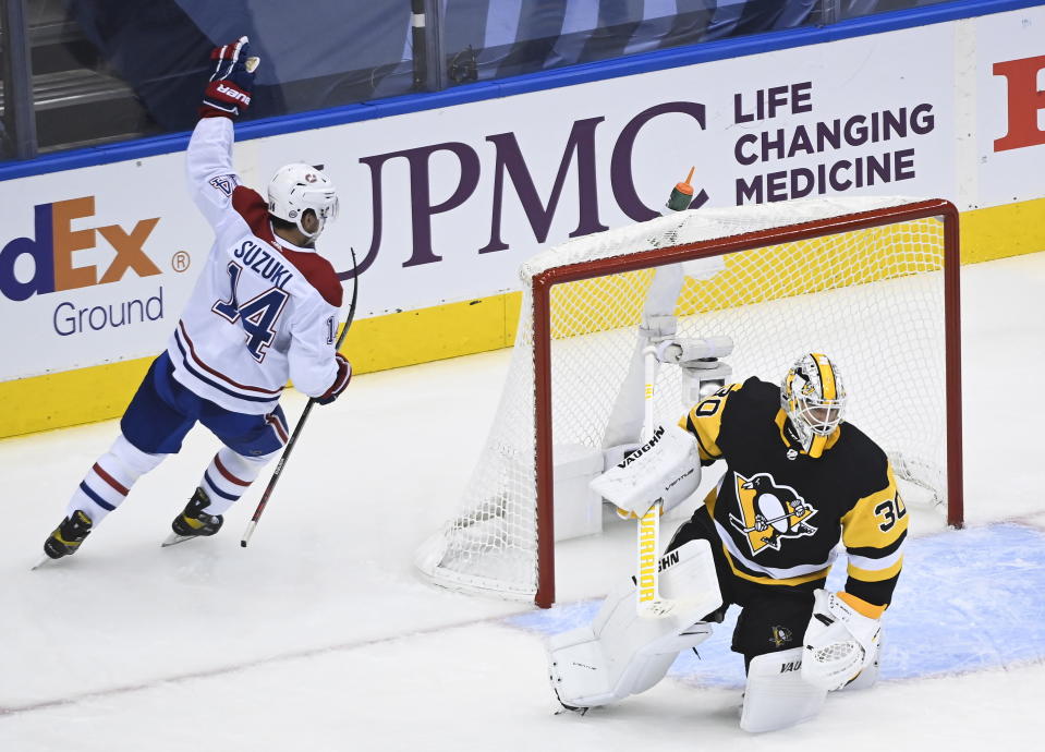 Montreal Canadiens center Nick Suzuki (14) scores against Pittsburgh Penguins goaltender Matt Murray (30) during second-period NHL Eastern Conference Stanley Cup playoff hockey game action in Toronto, Saturday, August 1, 2020. (Nathan Denette/The Canadian Press via AP)