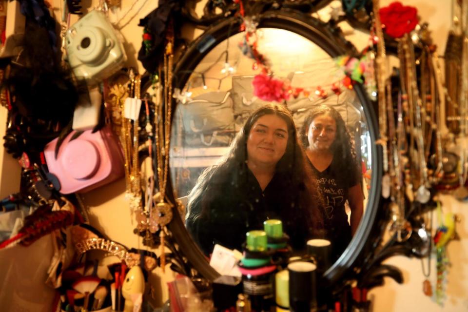 America Ramirez Lomeli and her mother Ziria Lomeli are reflected in a mirror