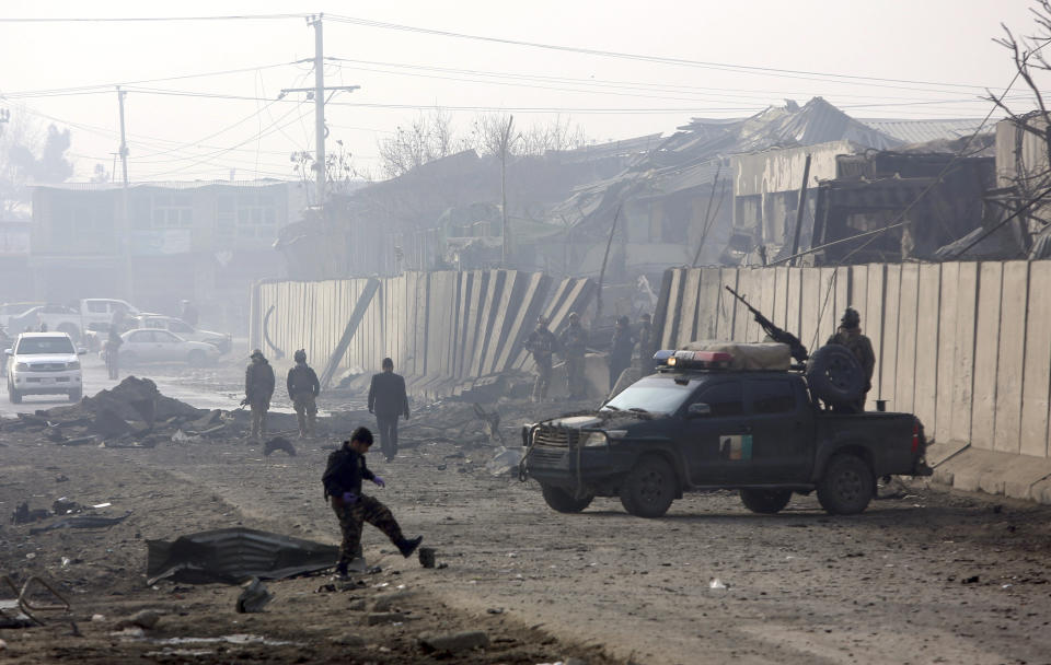 Afghan security forces gather at the site a day after an attack in Kabul, Afghanistan, Tuesday, Jan. 15, 2019. A Taliban suicide bomber detonated an explosive-laden vehicle in the capital Kabul on Monday evening, according to officials. (AP Photo/Rahmat Gul)