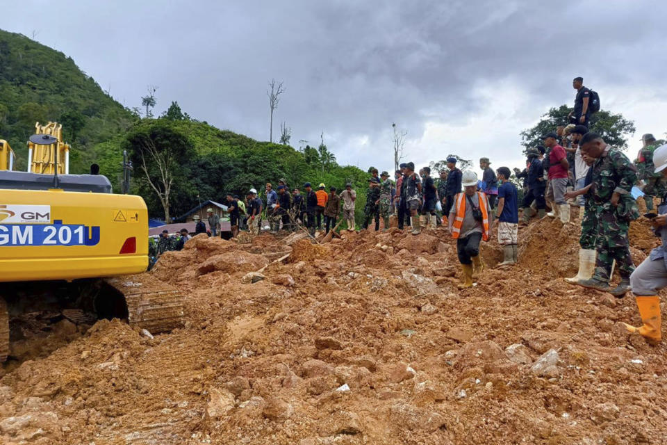 In this photo released by the Indonesian National Search and Rescue Agency (BASARNAS), rescuers search for victims at the site of a landslide in Suwawa on Sulawesi Island, Indonesia, Wednesday, July 10, 2024. Search efforts for those trapped in a deadly landslide intensified Wednesday, with more rescuers deployed to search an unauthorized gold mine on Indonesia's Sulawesi island that saw a number of deaths over the weekend. (BASARNAS via AP)