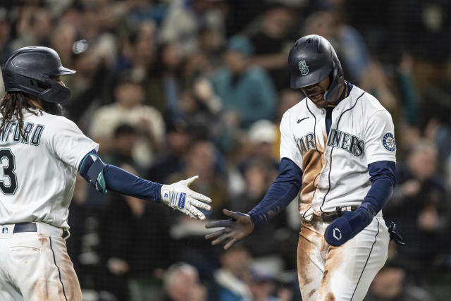 Seattle Mariners' Ty France flips his bat after hitting a home run