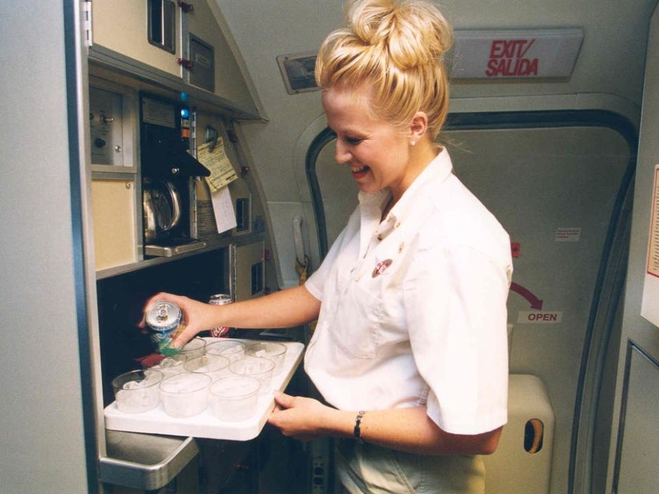 Southwest Airlines flight attendant preparing beverage orders in the galley