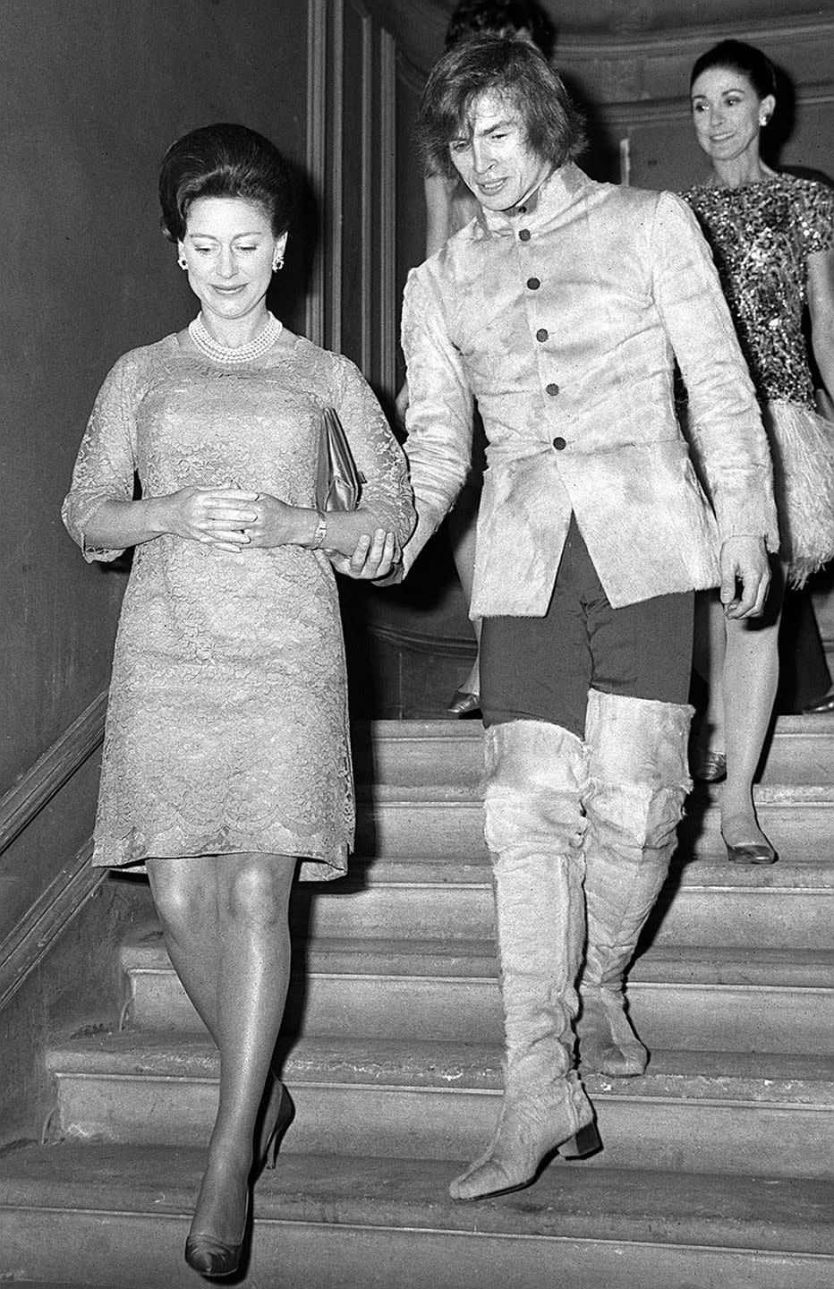 <p>Ballet dancer Rudolf Nureyev accompanies Princess Margaret down the stairs of the Royal Academy of Dancing in Knightsbridge in 1968.</p>