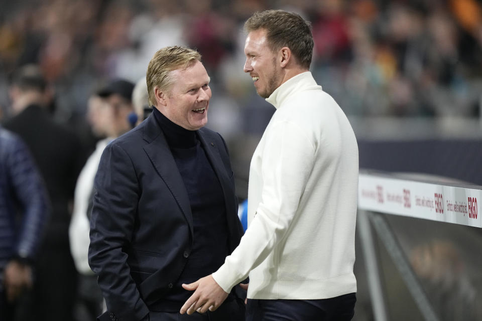 Netherlands' head coach Ronald Koeman, left, talks to Germany's head coach Julian Nagelsmann prior the start of the international friendly soccer match between Germany and Netherlands at the Deutsche Bank Park in Frankfurt, Germany on Tuesday, March 26, 2024. (AP Photo/Martin Meissner)