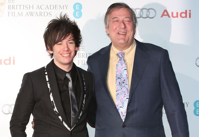 <p>Tim P. Whitby/Getty</p> Elliott Spencer and Stephen Fry in 2015