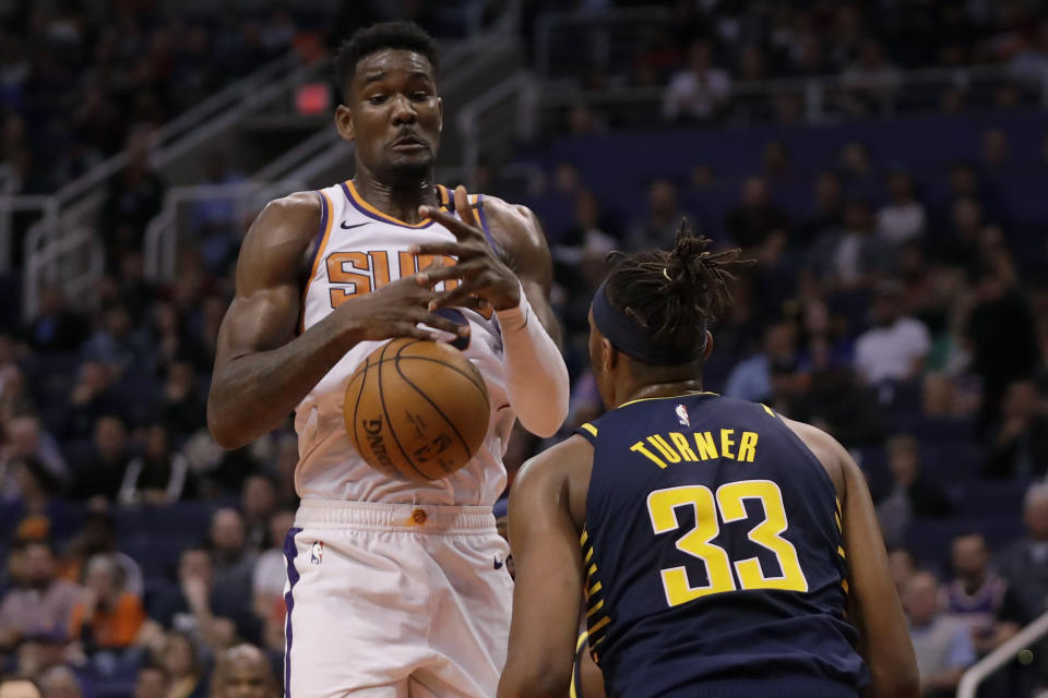 Indiana Pacers center Myles Turner (33) knocks the ball away from Phoenix Suns center Deandre Ayton (22) during the second half of an NBA basketball game, Wednesday, Jan. 22, 2020, in Phoenix. (AP Photo/Matt York)