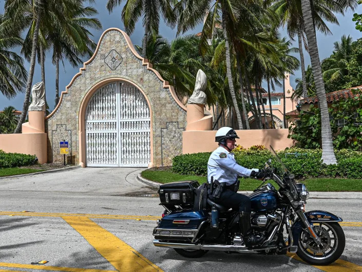 Local law enforcement officers are seen in front of the home of former President Donald Trump at Mar-A-Lago in Palm Beach, Florida on August 9, 2022. - Former US president Donald Trump said August 8, 2022 that his Mar-A-Lago residence in Florida was being 