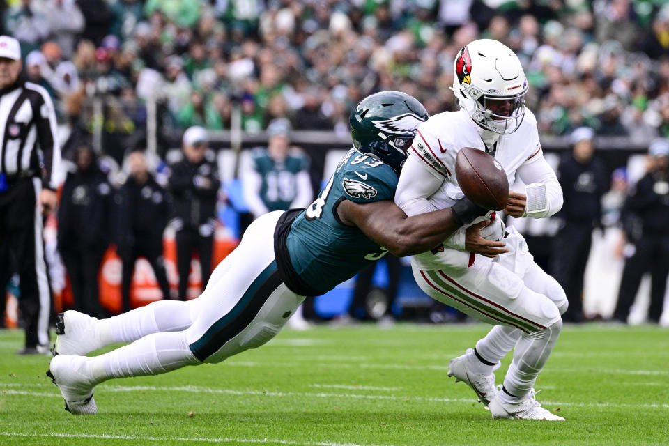 Philadelphia Eagles defensive tackle Milton Williams, left, forces Arizona Cardinals quarterback Kyler Murray to fumble the ball during the first half of an NFL football game, Sunday, Dec. 31, 2023, in Philadelphia. Murray recovered the fumble. (AP Photo/Derik Hamilton)