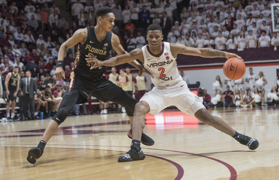 Virginia Tech guard Landers Volley (2) keeps ball away from Florida State defender Devin Vassell (24) during the second half of an NCAA college basketball game in Blacksburg, Va., Saturday, Feb. 1, 2020. (AP Photo/Lee Luther Jr.)