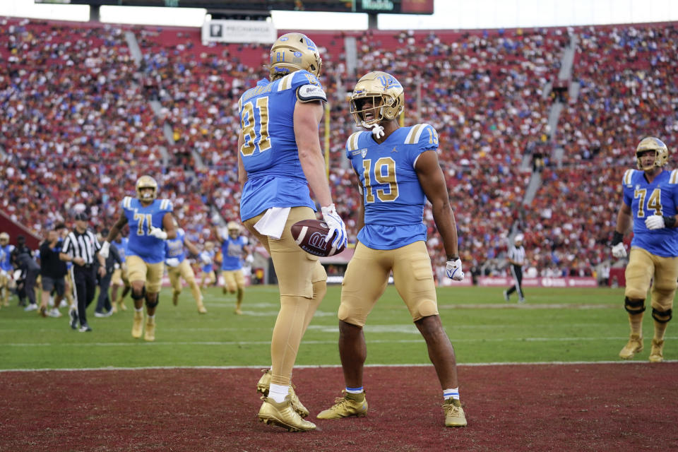 UCLA tight end Hudson Habermehl (81) celebrates with wide receiver Kyle Ford (19) after scoring during the first half of an NCAA college football game against Southern California in Los Angeles, Saturday, Nov. 18, 2023. (AP Photo/Ashley Landis)