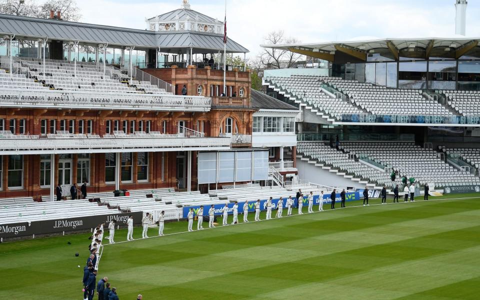 Players and staff stand for two minutes silence at Lord's prior to day two between Middlesex and Somerset - GETTY IMAGES