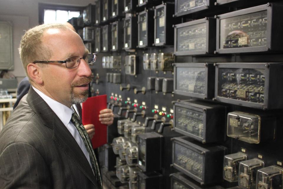 This handout photo, taken in July 2011, provided by the Federal Transit Administration, shows Peter Rogoff, administrator of the Federal Transit Administration looking at electrical equipment at the Southeastern Pennsylvania Transportation Authority’s Jenkintown power station that has been operating with outdated circuits and electrical equipment from the 1930s. Driven by high gas prices and an uncertain economy, Americans are turning to trains and buses to get around in greater numbers than ever before. The aging trains and buses they’re riding, however, face an $80 billion maintenance backlog that jeopardizes service just when it’s most in demand. (AP Photo/Federal Transit Administration)