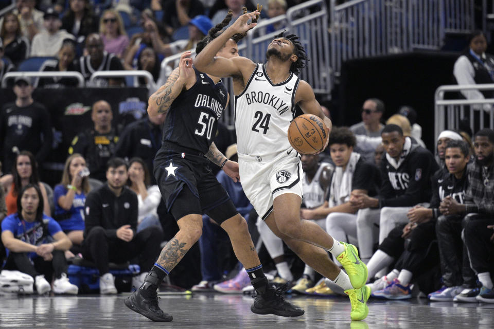 Brooklyn Nets guard Cam Thomas (24) is fouled by Orlando Magic guard Cole Anthony (50) during the first half of an NBA basketball game, Sunday, March 26, 2023, in Orlando, Fla. (AP Photo/Phelan M. Ebenhack)