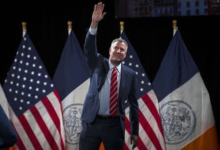 New York City Mayor Bill de Blasio waves to the audience after delivering his State of the City address at Baruch College in the Manhattan borough of New York City, February 3, 2015. REUTERS/Mike Segar