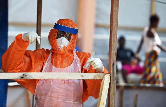 A health worker wearing a personal protective equipment works in the red zone of the Hastings treatment center in Hastings, outside Freetown on November 11, 2014 (AFP Photo/Francisco Leong)