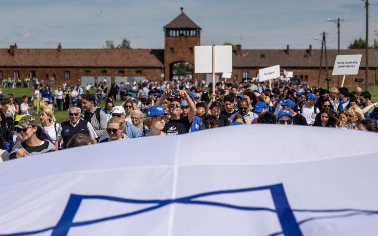 Participants display a large Israeli flag during the march, which honoured victims of the Holocaust