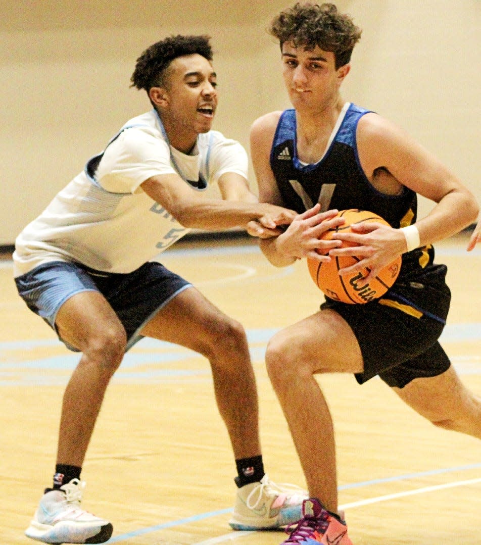 Bartlesville High School senior Jordan Carter, left, disrupts the drive of a Victory Christian player during basketball scrimmage action last November at the Bruin Fieldhouse.