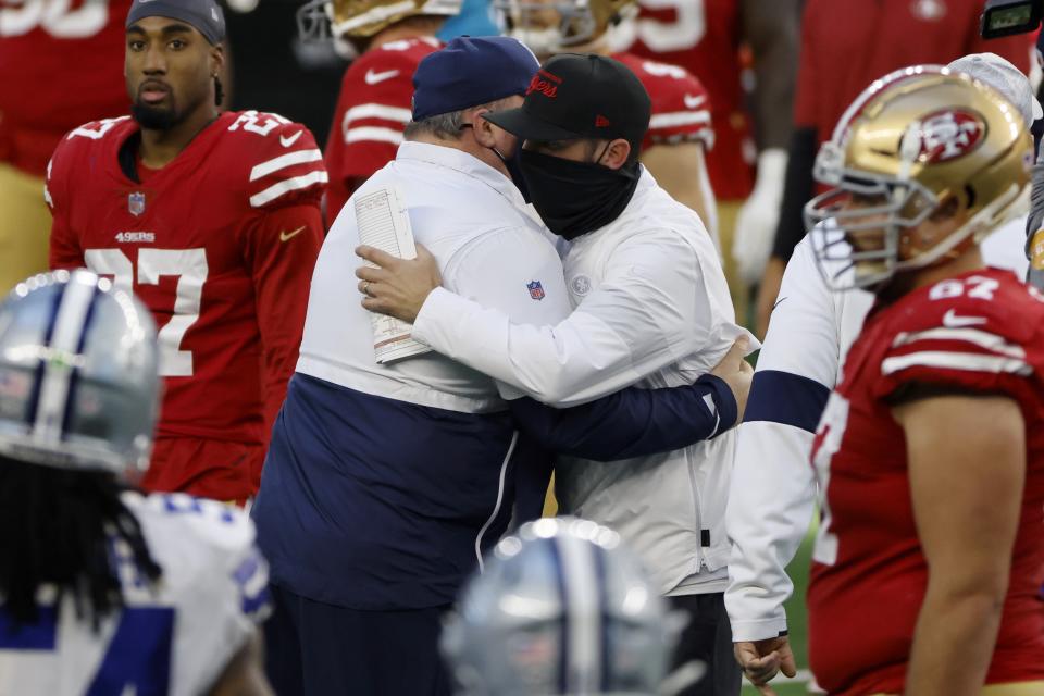 Dallas Cowboys head coach Mike McCarthy, center left, and San Francisco 49ers head coach Kyle Shanahan, center right, greet each other after their NFL football game in Arlington, Texas, Sunday, Dec. 20, 2020. (AP Photo/Ron Jenkins)