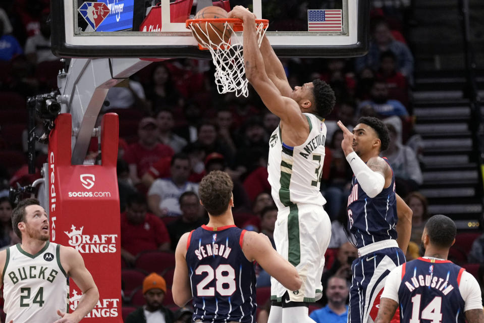 Milwaukee Bucks forward Giannis Antetokounmpo dunks during the first half of the team's NBA basketball game against the Houston Rockets, Friday, Dec. 10, 2021, in Houston. (AP Photo/Eric Christian Smith)