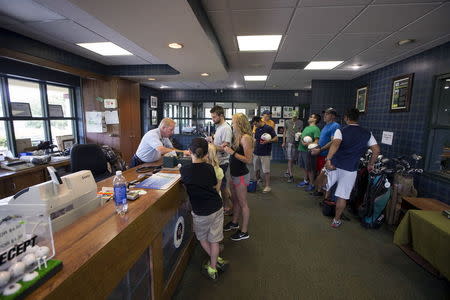 FootGolfers stand in the pros shop before teeing off at Largo Golf Course in Largo, Florida April 11, 2015. REUTERS/Scott Audette