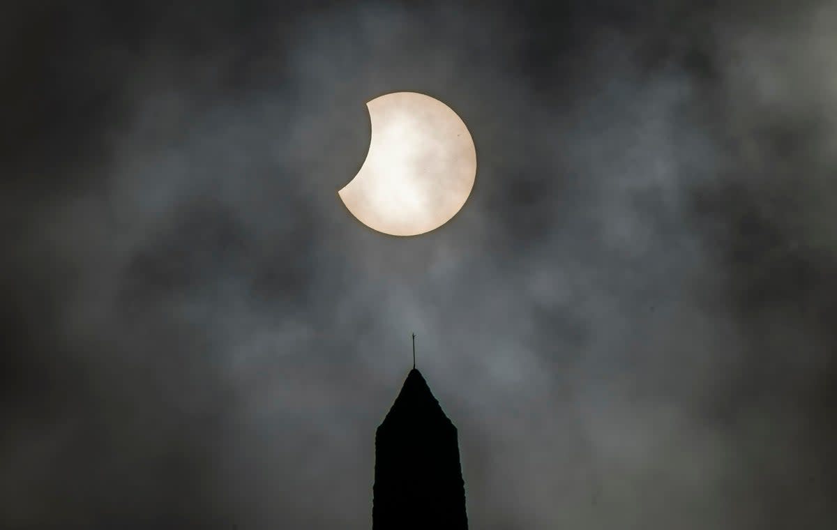 The partial solar eclipse over Stoodley Pike in West Yorkshire (PA)