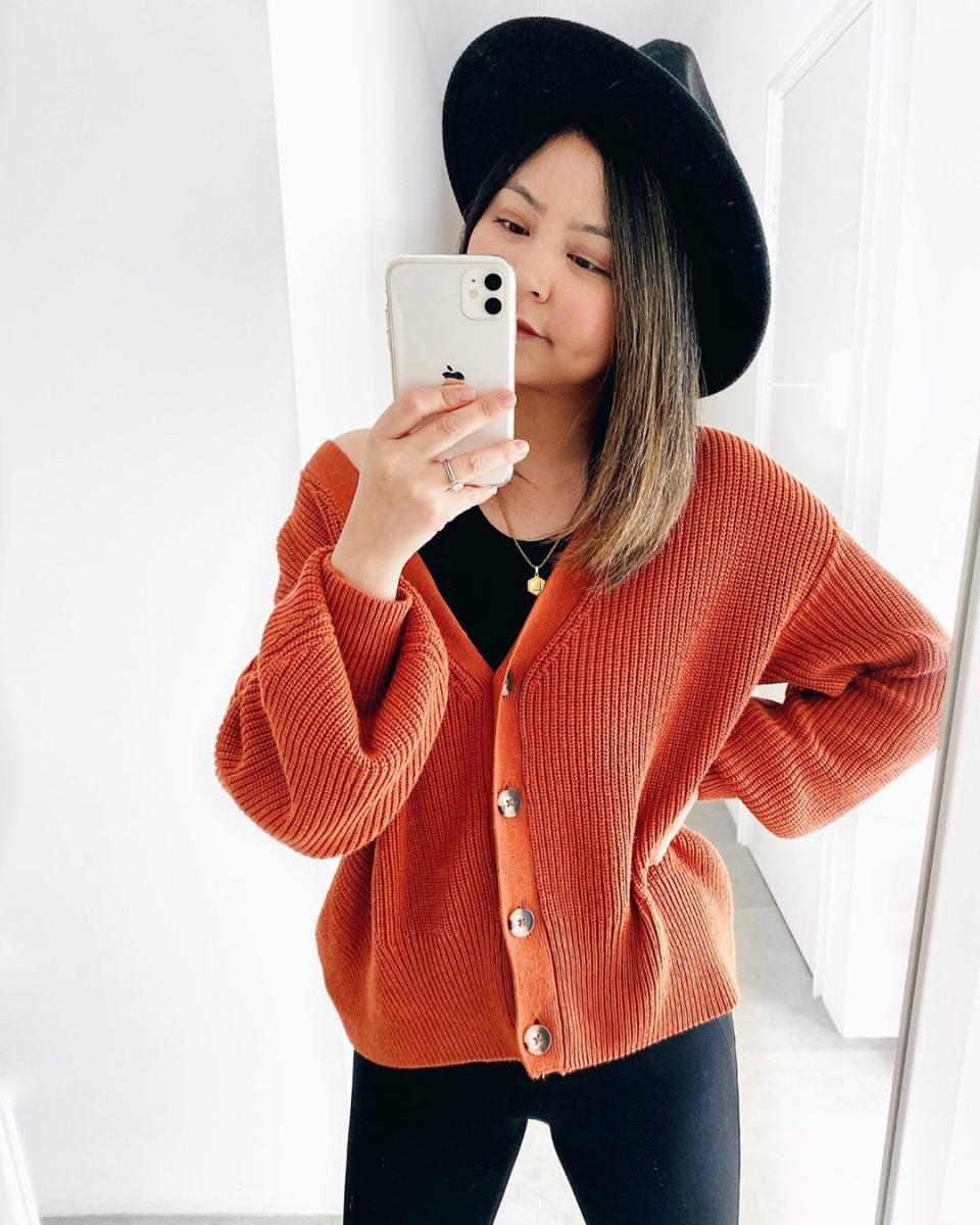 Woman in burnt orange cardigan