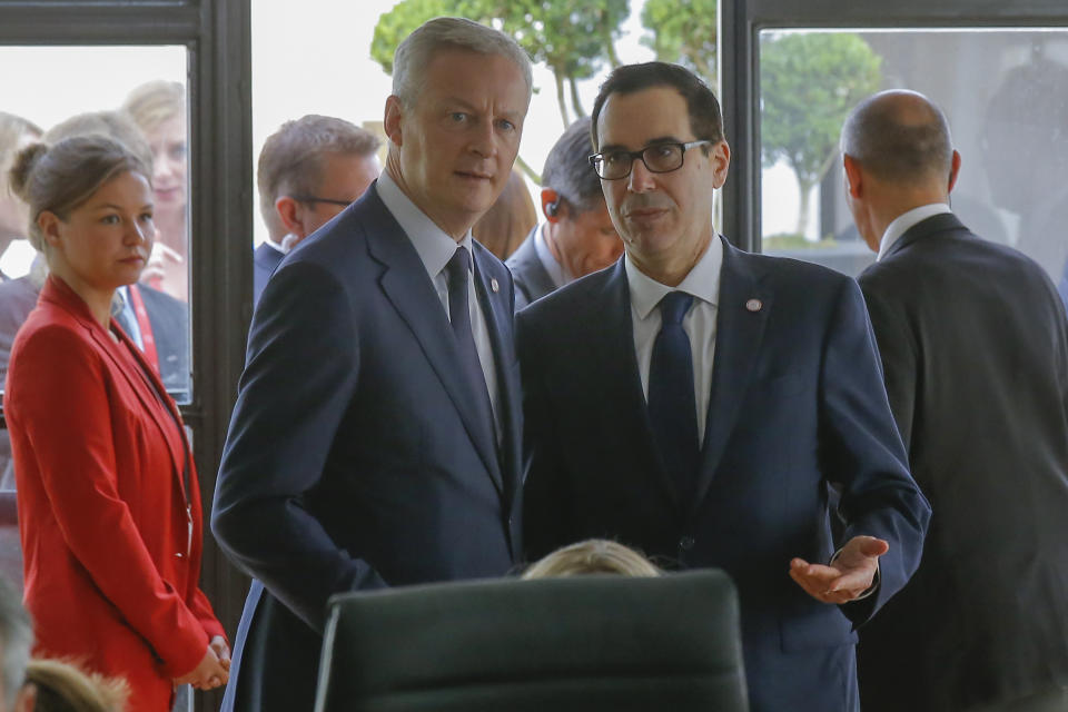 French Finance Minister Bruno Le Maire, left, talks to US Treasury Secretary Steve Mnuchin during a meeting at the G-7 Finance in Chantilly, north of Paris, on Thursday, July 18, 2019. (AP Photo/Michel Euler)