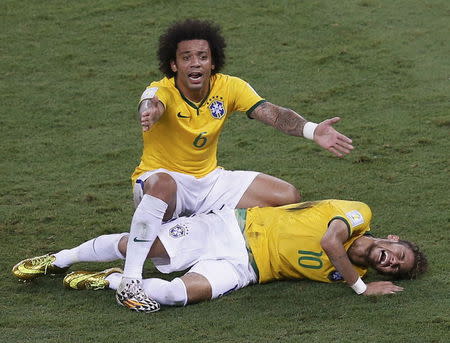 No. 4 - THE FOUL. Brazil's World Cup effectively ended when Colombia defender Juan Zuniga charged into their marquee striker Neymar with a raised knee, leaving him in tears on a stretcher with a broken vertebra. Brazil won that game 2-1, but the emotionally fragile team collapsed afterwards, losing 7-1 to Germany. REUTERS/Leonhard Foeger