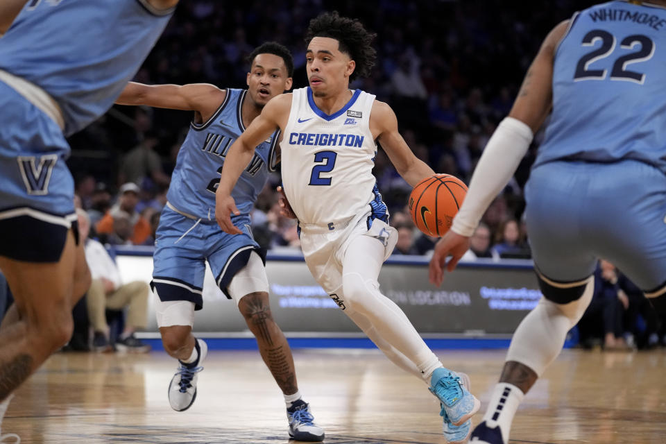 Creighton's Ryan Nembhard (2) drives past Villanova's Mark Armstrong, center left, in the first half of an NCAA college basketball game during the quarterfinals of the Big East conference tournament, Thursday, March 9, 2023, in New York. (AP Photo/John Minchillo)