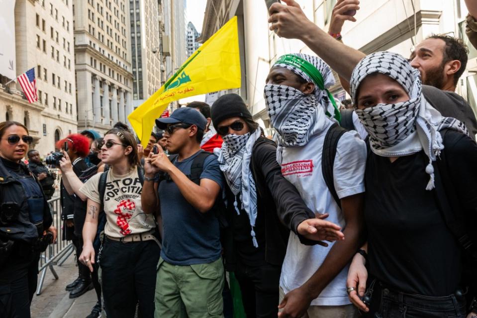 Videos taken during the Wall Street leg of the protest show at least one masked activist proudly displaying Hezbollah’s flag emblazoned with the image of an assault rifle. Getty Images