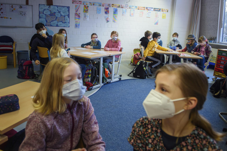 Pupils attend a lesson at the 'Russee' elementary school in Kiel, northern Germany, Monday, Feb. 22, 2021. Elementary schools and kindergartens in more than than half of Germany's 16 states reopened Monday after two months of closure due to the coronavirus pandemic. The move comes despite growing signs that the decline in case numbers in Germany is flattening out again and even rising in some areas. (Gregor Fischer/dpa via AP)