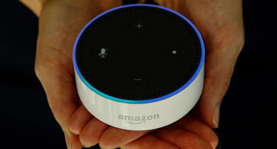 An attendee holds an "Echo Dot" device during the U.K. launch event for the Amazon Echo voice-controlled home assistant speaker.