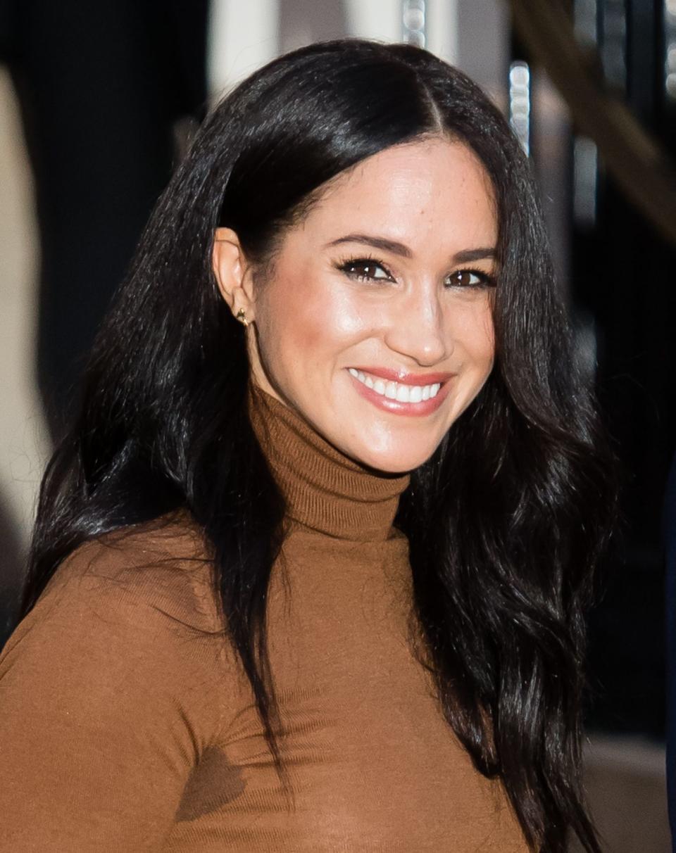 Meghan Markle smiling for the cameras