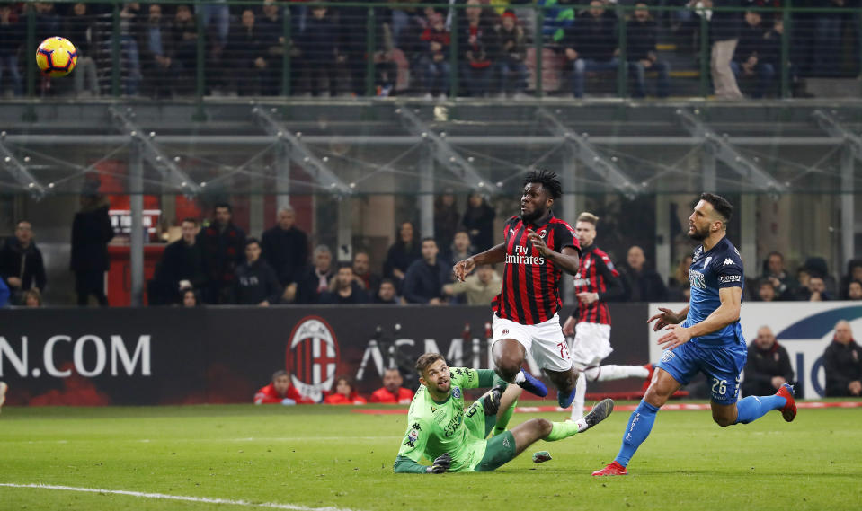 AC Milan's Franck Kessie, top left, scores his side's second goal during the Serie A soccer match between AC Milan and Empoli at the San Siro stadium, in Milan, Italy, Friday, Feb. 22, 2019. (AP Photo/Antonio Calanni)