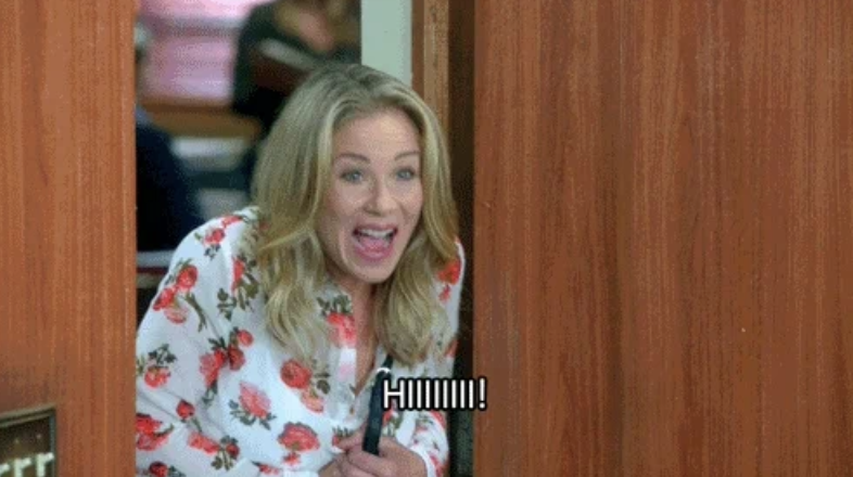 Christina Applegate excitedly peeks around a doorframe, wearing a floral-patterned top, with "HIIIII!" captioned at the bottom