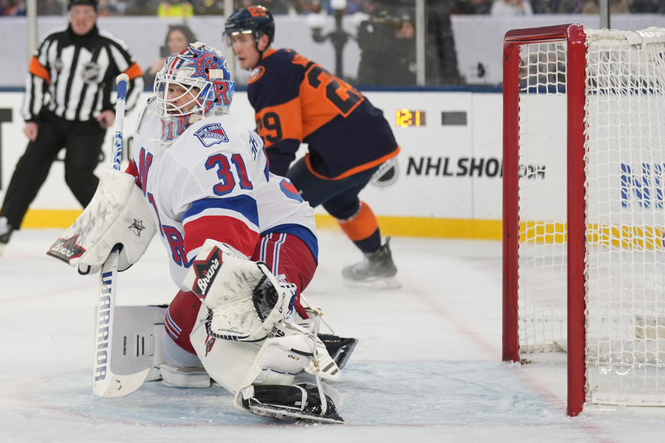 New York Rangers goaltender Igor Shesterkin (31) makes a glove save during the second period of an NHL Stadium Series hockey game against the New York Islanders in East Rutherford, N.J., Sunday, Feb. 18, 2024. (AP Photo/Seth Wenig)