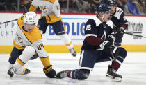 Colorado Avalanche right wing Nicolas Aube-Kubel, right, loses control of the puck as Nashville Predators left wing Tanner Jeannot defends in the second period of an NHL hockey game Saturday, Nov. 27, 2021, in Denver. (AP Photo/David Zalubowski)