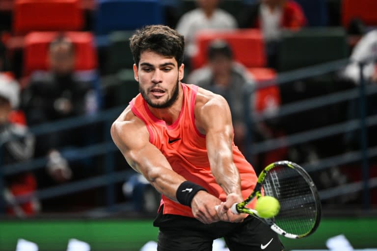 Spain's Carlos Alcaraz hits a return to China's Shang Juncheng during their men's singles match at the Shanghai Masters tennis tournament (HECTOR RETAMAL)