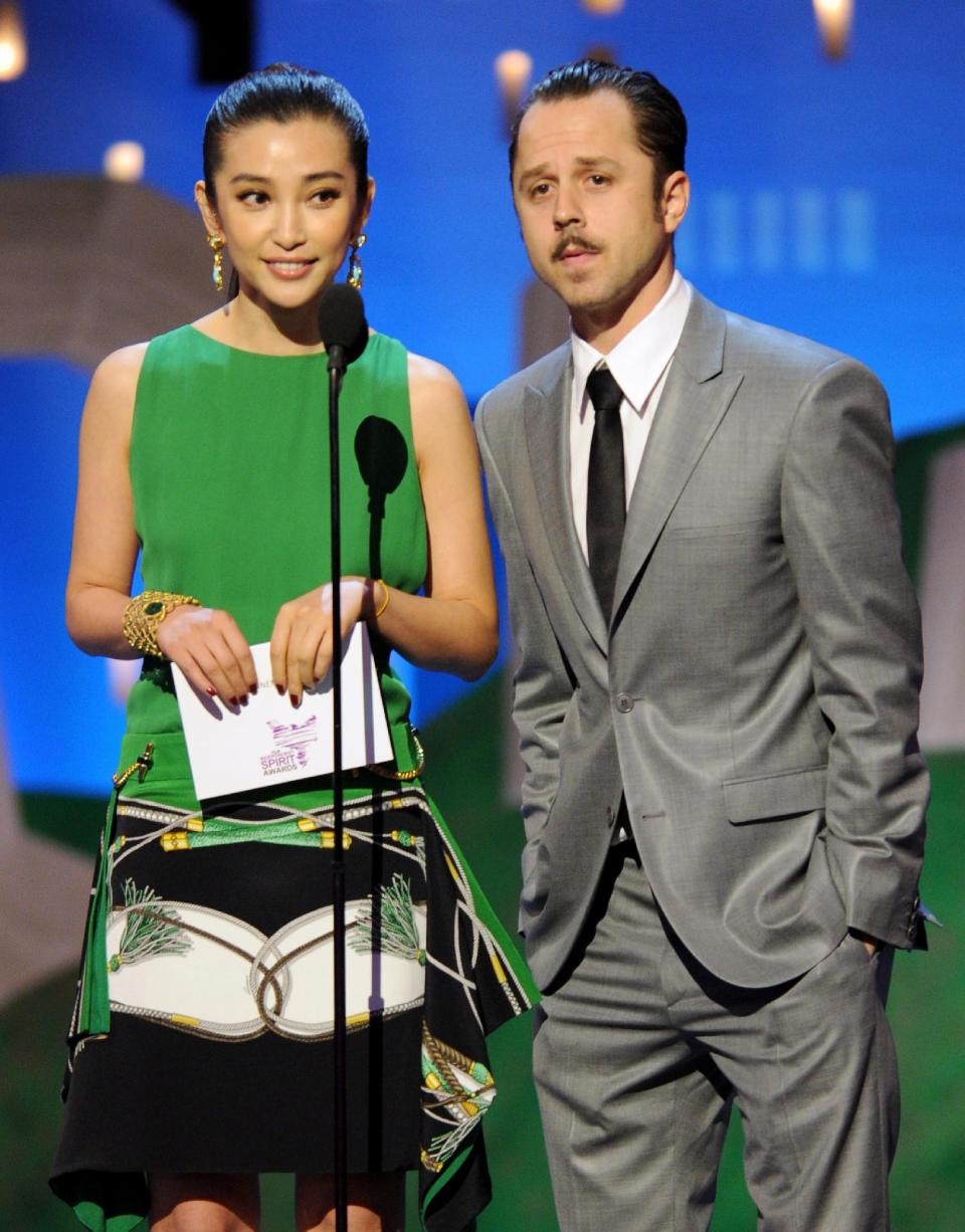 Bingbing Li, left, and Giovanni Ribisi present an award onstage at the Independent Spirit Awards on Saturday, Feb. 25, 2012, in Santa Monica, Calif. (AP Photo/Vince Bucci)