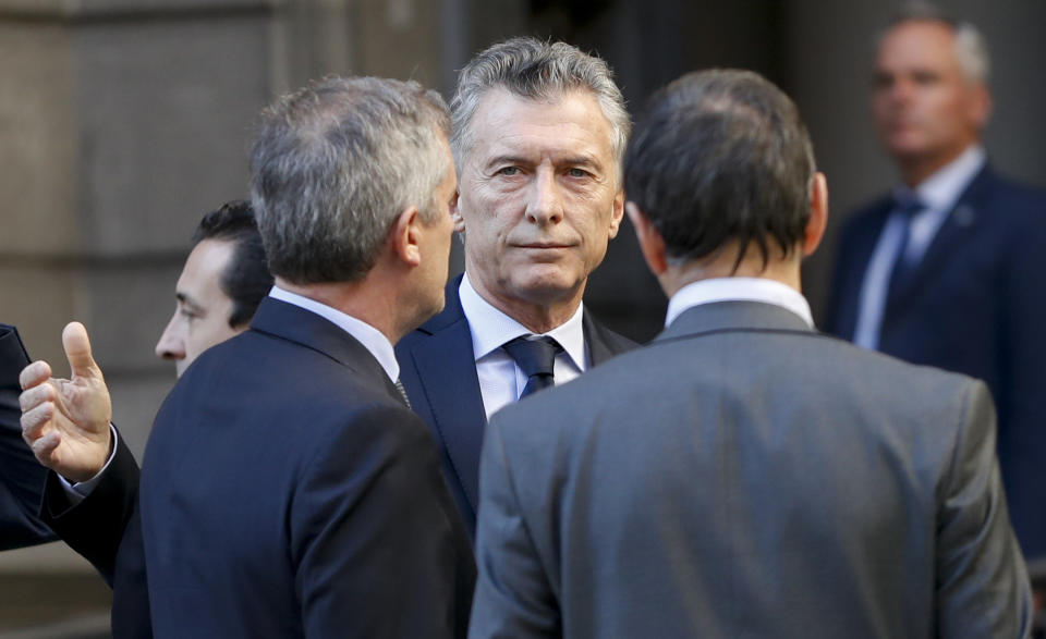 President Mauricio Macri leaves Congress after attending the wake for lawmaker Hector Olivares who was shot near the Congressional building last week in Buenos Aires, Argentina, Monday, May 13, 2019. Olivares died three days after being seriously wounded in a May 9 gun attack that also killed a provincial official. (AP Photo/Natacha Pisarenko)