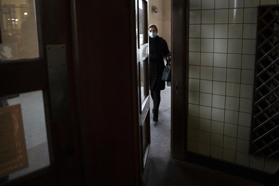 A woman wearing a face mask to protect against coronavirus enters a subway station in Moscow, Russia, Tuesday, Nov. 3, 2020. Russia reported more than 18,000 daily coronavirus cases for a record five straight days. However, authorities have resisted a second lockdown or shutting down businesses despite reports about overwhelmed hospitals, drug shortages and inundated medical workers. (AP Photo/Pavel Golovkin)