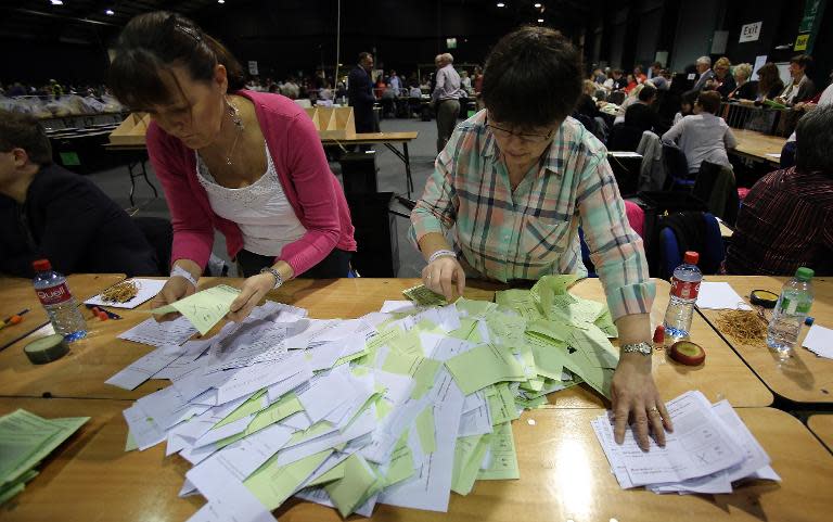 People sort ballot papers at a count centre in Dublin following the vote on same-sex marriage in Ireland on May 23, 2015