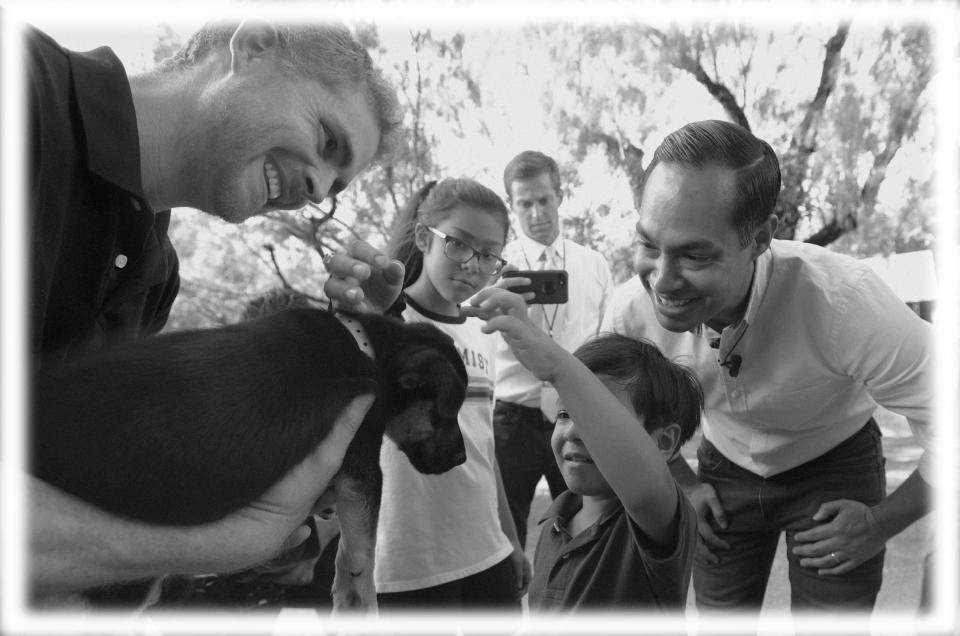Julian Castro, right, with his son Cristian, and daughter Carina, visit with Ivan, a puppy up for adoption, during a stop at the Animal Defense League of Texas shelter, Monday, Aug. 19, 2019, in San Antonio. (Photo: Eric Gay/AP; digitally enhanced by Yahoo News)