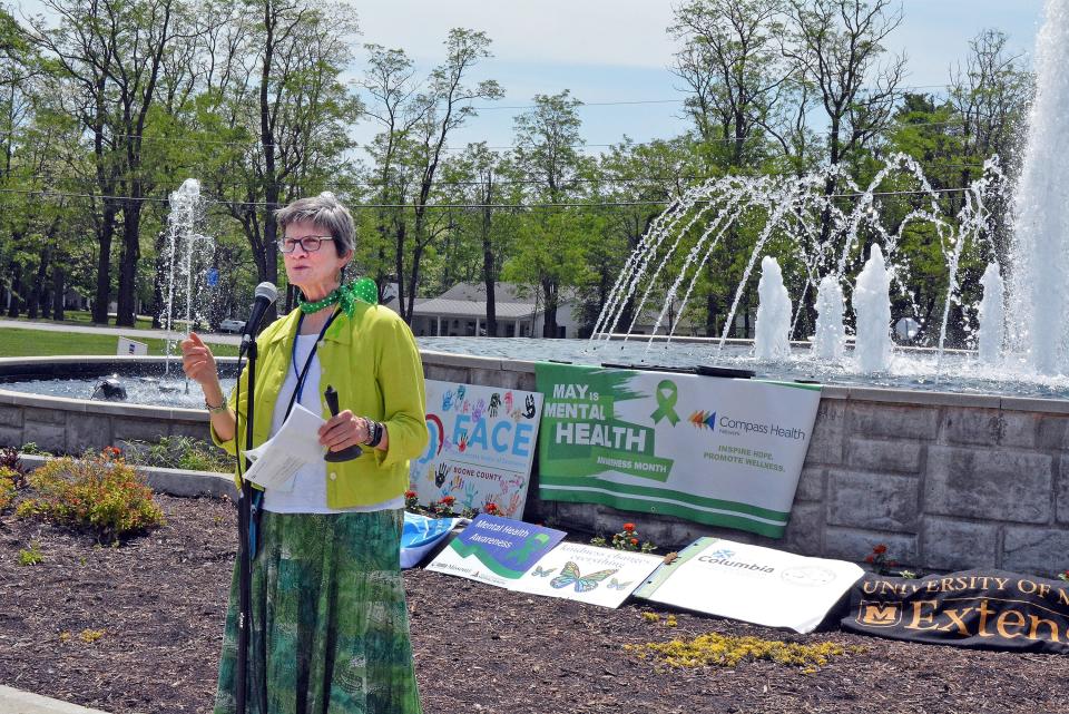 Columbia Boone County Public Health and Human Services Health Educator Heather Harlan welcomes guests Wednesday to the Shelter Insurance fountain for a recognition of Children's Mental Health Week. 