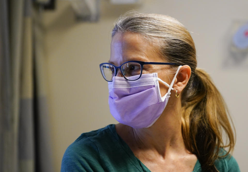 Kathleen Jade poses for a portrait while waiting to receive her third dose of an experimental breast cancer vaccine at University of Washington Medical Center - Montlake, Tuesday, May 30, 2023, in Seattle. Jade, 50, learned she had breast cancer in late February. She's getting the vaccine to see if it will shrink her tumor before surgery. “Even if that chance is a little bit, I felt like it’s worth it," said Jade, who is also getting standard treatment. (AP Photo/Lindsey Wasson)