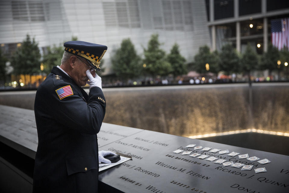 NEW YORK, NY - SEPTEMBER 11: Sam Pulia, mayor of Westerchester, IL, and a former police officer of the same town, mourns over the name of his cousin, New York firefighter Thomas Anthony Casoria, who was killed in the South Tower, prior to the the memorial observances held at the site of the World Trade Center in in New York on September 11, 2014. This year marks the 13th anniversary of the September 11th terrorist attacks that killed nearly 3,000 people at the World Trade Center, Pentagon and on Flight 93. (Photo by Andrew Burton - Pool /Getty Images)